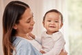 Happy baby, happy mom. Portrait of an adorable baby girl being held by her mother at home. Royalty Free Stock Photo