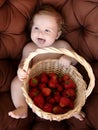Happy baby have fun in the Park on a Sunny meadow with strawberry. Summer vacation concept. The emotions Royalty Free Stock Photo