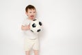 Happy baby holding a soccer ball on a studio white background. Smilin Royalty Free Stock Photo