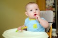 Happy baby infant boy eating meal Royalty Free Stock Photo