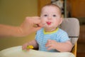 Happy baby infant boy eating meal Royalty Free Stock Photo