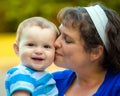 Happy baby kissed by mom