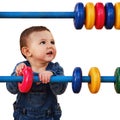 Happy baby learning math on abacus while playing on playground, isol Royalty Free Stock Photo