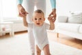 Happy baby learning to walk with mother help Royalty Free Stock Photo