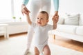 Happy baby learning to walk with mother help Royalty Free Stock Photo