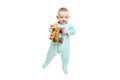 Happy baby lies in mint color clothes with wooden toys, isolated on a w Royalty Free Stock Photo