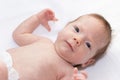 Happy baby lying on white sheet. Cute adorable baby is 1 month old. Dry and healthy body and skin for children concept. Royalty Free Stock Photo