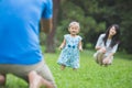 Happy baby making his first steps on a green grass Royalty Free Stock Photo