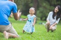 Happy baby making his first steps on a green grass Royalty Free Stock Photo