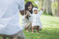 Happy baby making his first steps on a green grass Royalty Free Stock Photo