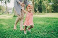 Happy baby making his first steps on a green grass Royalty Free Stock Photo