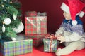 Happy baby with many gift box near decorated Christmas tree Royalty Free Stock Photo