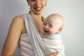 Happy baby and mother. Baby near mother in a sling.