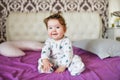 Happy baby after a nap. healthy sleep, the guarantee of a vigorous child. Cute little baby boy, relaxing in bed after bath, Royalty Free Stock Photo