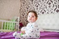 happy baby after a nap. healthy sleep, the guarantee of a vigorous child. Cute little baby boy, relaxing in bed after bath, Royalty Free Stock Photo