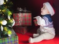 Happy baby near decorated Christmas tree with many gift box Royalty Free Stock Photo
