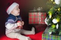 Happy baby near decorated Christmas tree with many gift box Royalty Free Stock Photo