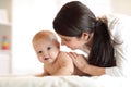 Happy baby near to mom in room Royalty Free Stock Photo