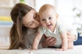 Happy baby near to mom in room Royalty Free Stock Photo