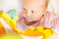 Happy baby playing with children's musical mobile toy Royalty Free Stock Photo