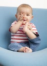 Happy baby's teething with her hands Royalty Free Stock Photo