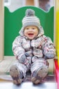 Happy baby on slide Royalty Free Stock Photo