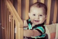Happy baby standing up in his crib Royalty Free Stock Photo
