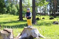 Happy baby on stub in forest Royalty Free Stock Photo
