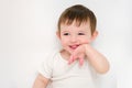 A happy baby on a studio white background. Portrait of a smiling child. Royalty Free Stock Photo