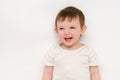 A happy baby on a studio white background. Portrait of a smiling child. Royalty Free Stock Photo