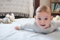 A happy baby toddler child lying on a play mat looking directly at the camera and smiling - tummy time concept Royalty Free Stock Photo