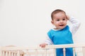 Happy baby toddler look at one side in the bed with hand on head on white background Royalty Free Stock Photo