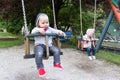 Happy Baby Twins Playing With the Swing Royalty Free Stock Photo