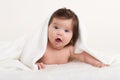 Happy baby under towel on white Royalty Free Stock Photo