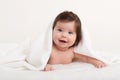 Happy baby under towel on white Royalty Free Stock Photo