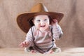 Happy baby wearing cow girl outfit with big hat Royalty Free Stock Photo