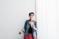 Happy backpacker caucasian woman at train station using mobile phone app while waiting. Travel concept Royalty Free Stock Photo