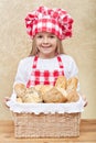 Happy baker holding a basket with fresh products