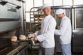 Happy baker holding tray of fresh bread Royalty Free Stock Photo