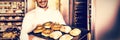 Happy baker showing tray of fresh bread Royalty Free Stock Photo