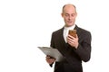 Happy bald Caucasian businessman smiling and holding clipboard w Royalty Free Stock Photo