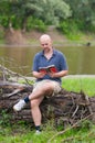 Happy bald man reading the book