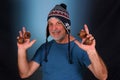 happy bald man with white beard Peruvian cap on his head playing musical instrument asalato looking forward with good expression