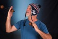 happy bald man with white beard Peruvian cap on his head playing musical instrument asalato looking forward with good expression Royalty Free Stock Photo