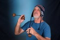 happy bald man with white beard Peruvian cap on his head playing musical instrument asalato looking forward with good expression