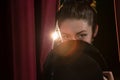 Ballet dancer with hat peeking through a stage curtain Royalty Free Stock Photo