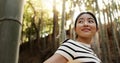 Happy, bamboo and Japanese woman in forest for adventure on holiday, vacation and morning in woods. Travel, nature and