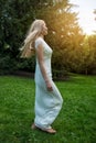 Happy barefoot beautiful woman having fun and running on green grass outdoors Royalty Free Stock Photo