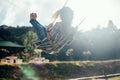 Happy barefoot girl on swing in sun light Royalty Free Stock Photo