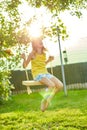 Happy barefoot laughing child girl swinging on a swing in sunset summer day Royalty Free Stock Photo